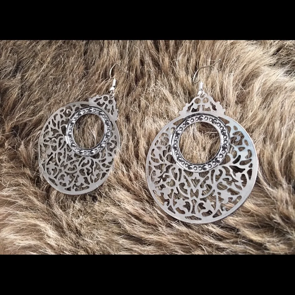 Large chrome tone scroll rhinestone earrings
